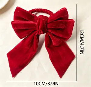 Detail of a red velvet bow napkin ring showing dimensions 12cm x 10cm for holiday decor