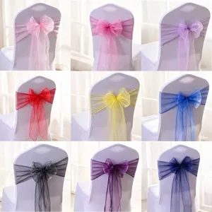 Assorted colors of organza chair sashes tied in bows for wedding banquet decoration