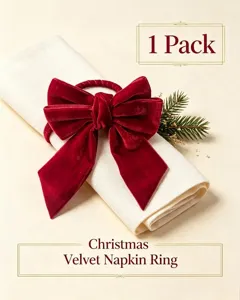 Detailed macro view of a red velvet Christmas bow napkin ring set on a white napkin