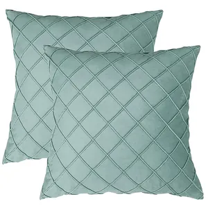 Pair of sage green velvet throw pillow covers with decorative diamond lattice pattern