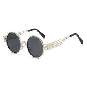 Lunettes de soleil steampunk vintage avec monture en métal évidé et verres ronds style rétro chic.