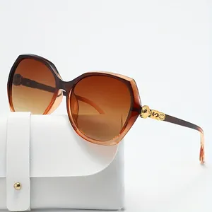 Oversized polygonal women's sunglasses with gradient brown lenses and gold temple detail