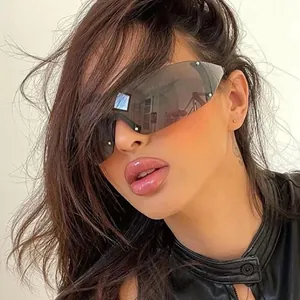 Detailed view of futuristic Y2K rimless shield sunglasses worn by a fashion model