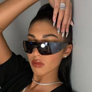 Detailed view of futuristic Y2K rimless shield sunglasses worn by a fashion model