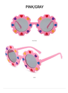 Simpatici occhiali da sole per bambini a forma di fiore rosa con cuori e lenti grigie.
