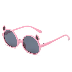 Adorable pink children's sunglasses with cartoon cat ear accents and round dark lenses