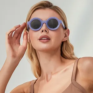 Fashionable purple round frame sunglasses worn by a blonde model for a trendy street look