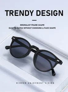 Close-up of retro black round sunglasses with silver rivet accents on acrylic stand