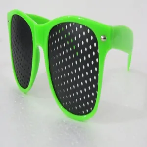 Detailed view of vibrant neon green fashion pinhole sunglasses for party favors