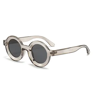 Trendy oversized round frame sunglasses with translucent tea frames and dark lenses.