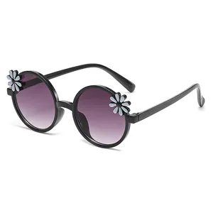 Stylish round black children's sunglasses with purple gradient lenses and daisy flower decor.