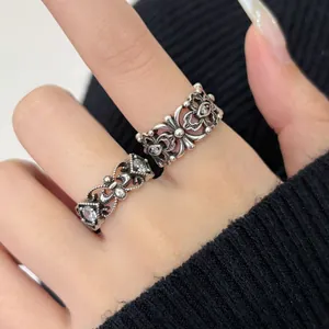 Close-up of retro distressed hollow carved rings with intricate floral patterns and stones