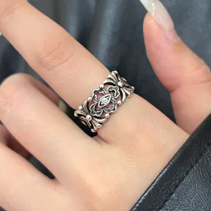 Detailed view of a vintage hollow carved Thai silver ring with floral patterns and cz