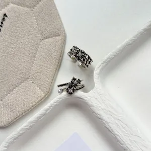 Macro view showing detailed floral engraving and stone settings on vintage silver rings