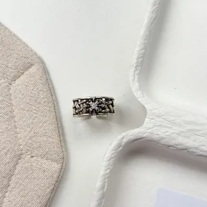 Detailed macro view of a vintage Thai silver floral open ring with crystal accents.