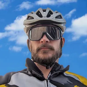 Detailed view of sports cycling sunglasses with a large frame on a model outdoors.