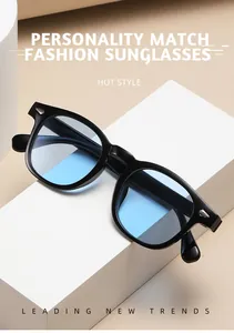 Close-up of retro round sunglasses with black frame, blue lenses, and silver pins
