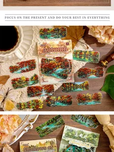 Detailansicht von Stickern mit Naturmotiven wie herbstlichen Wäldern und Wasserfällen