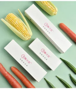 A top view of boxed double-rib sealed food storage bags with fresh corn and vegetables