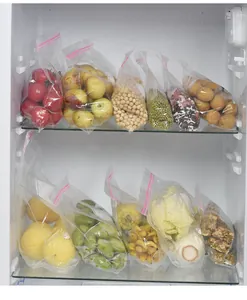 Transparent double-sealed food storage bags used for organizing fruits in a refrigerator.