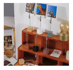 Detailed close-up of colorful wooden base alligator memo clips for photos and notes
