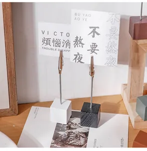 Detail view of a wooden base memo holder with crocodile clip for desk decoration