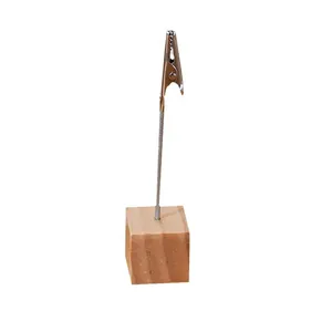Minimalist wooden cube base memo holder with metal alligator clip for desktop photos.