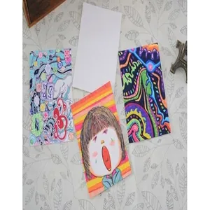 Detail view of handmade DIY drawing cards and bookmarks on a patterned background