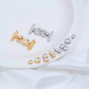 Detailed macro view of 14K gold-plated cubic zirconia jewelry findings and knot clasps