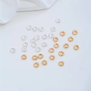 Detail of 14K gold and silver hammered closed ring spacers for DIY jewelry making.