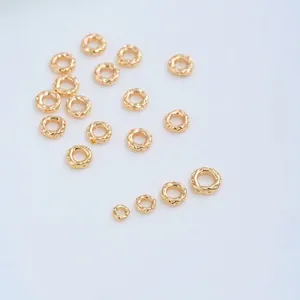 Macro view of textured 14K gold filled irregular spacer rings for DIY jewelry