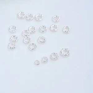 Macro view of silver textured spacer beads and closed rings for DIY jewelry making projects