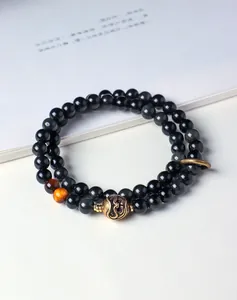Detailed view of double-strand silver sheen obsidian and tiger eye bead bracelet