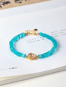 Close-up of a natural amazonite beaded bracelet with a golden gourd charm