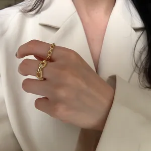Detailed macro view of a minimalist gold-plated silver chain ring with pig nose link.