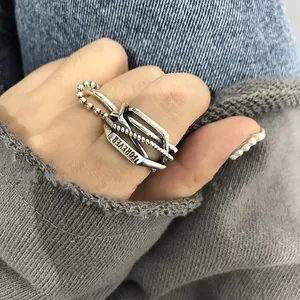 Close-up detail of vintage Thai silver geometric cross open ring engraved with Forever