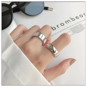 Close-up of a 925 sterling silver bold smooth open ring and beaded edge ring