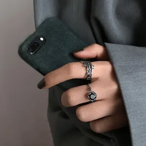 Close-up detail of retro Thai silver open rings with a black gemstone on a hand