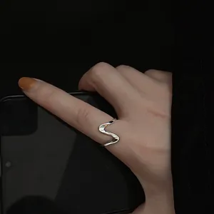 Detailed view of minimalist 925 sterling silver wavy open ring for women worn on finger