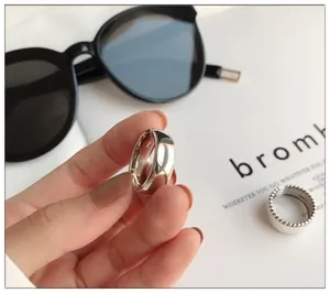 Detailed view of 925 sterling silver wide band open ring with glossy smooth finish
