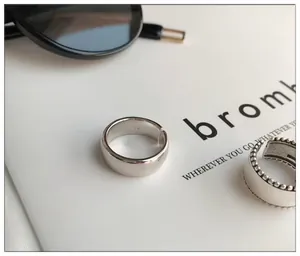 Macro detail of a 925 sterling silver bold smooth open ring with engraving
