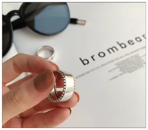 Macro view of a thick 925 sterling silver open ring featuring delicate beaded edge details