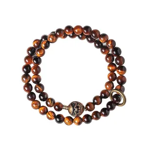 Elegant Tibetan style double wrap bracelet featuring tiger eye beads and bronze mask charms