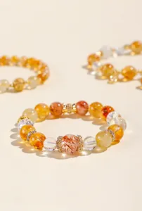 Detail view of natural rutilated quartz and citrine beads on an elegant crystal bracelet