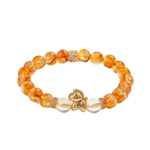 Elegante bracciale in perle di quarzo rutilato dorato naturale con ciondolo a cavallo portafortuna