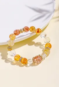 Detail of natural yellow rutilated quartz crystal beaded bracelet with gold spacers