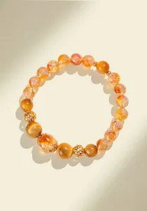 Macro detail of natural yellow tower quartz and golden tiger eye beaded bracelet with gold spacers
