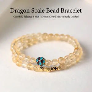 Elegante pulsera de doble capa con cuentas de citrino amarillo y un dije floral de esmalte