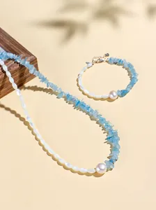 Elegant summer jewelry set with irregular blue aquamarine chips and white pearls.