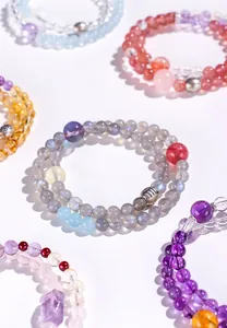 Nahaufnahme von bunten Kristallperlenarmbändern mit einem 925er Silber Sternzeichen-Anhänger.